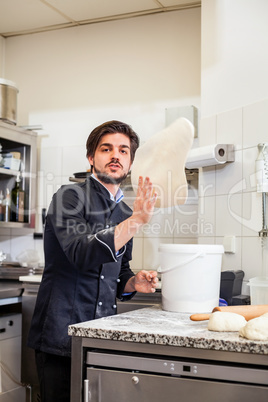 Chef tossing dough while making pastries