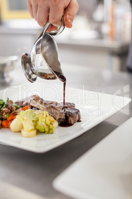 Chef plating up food in a restaurant