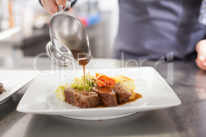 Chef plating up food in a restaurant