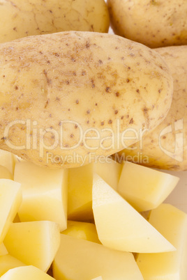 Whole Potatoes and Chopped Pieces on Cutting Board