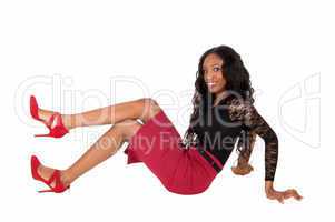 Black woman sitting on floor.