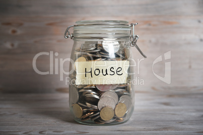 Coins in jar with house label