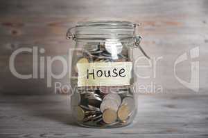 Coins in jar with house label