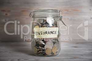 Coins in jar with insurance label