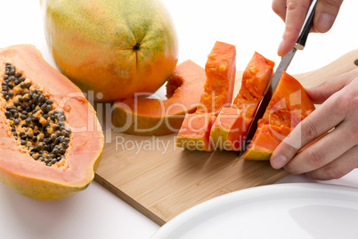 Half A Papaya Fruit Being Cut Into Slices