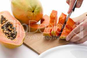 Half A Papaya Fruit Being Cut Into Slices