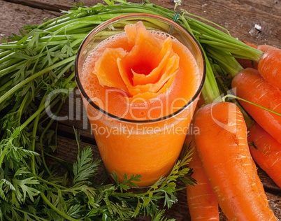 Fresh carrot juice glass with fresh organic carrots