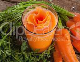 Fresh carrot juice glass with fresh organic carrots