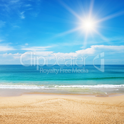 seascape and sun on blue sky background