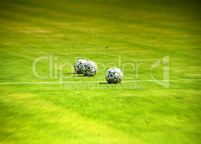 Soccer balls on the green field