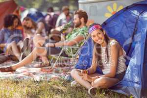 Carefree hipster smiling on campsite