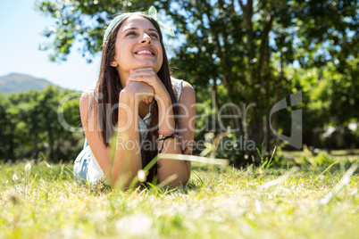 Pretty brunette lying on the grass