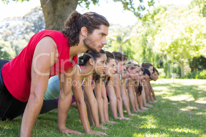 Fitness group planking in park