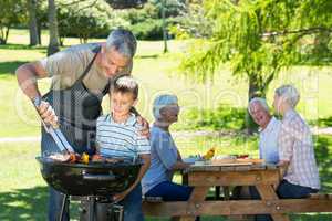 Happy father doing barbecue with his son