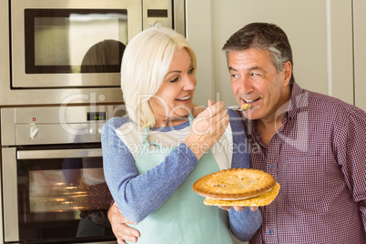 Happy mature blonde feeding pie to husband