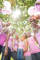 Smiling women in pink for breast cancer awareness