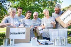 Happy volunteer family holding donation boxes