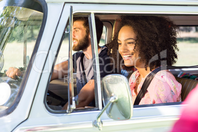 Hipster couple driving in camper van