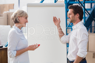 Manager showing something to his colleague on whiteboard