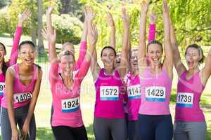 Smiling women running for breast cancer awareness