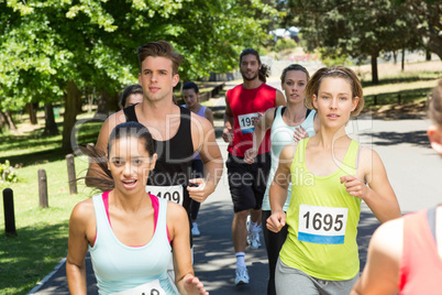 Fit people running race in park