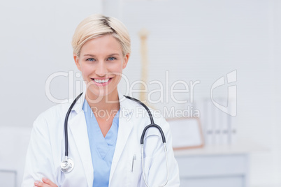 Confident female doctor smiling in clinic