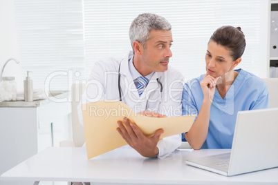 Doctors looking at files