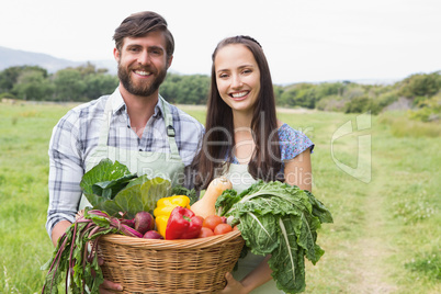 Happy couple with box of veg