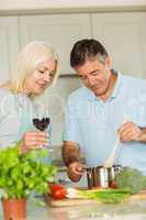 Happy mature couple making dinner together