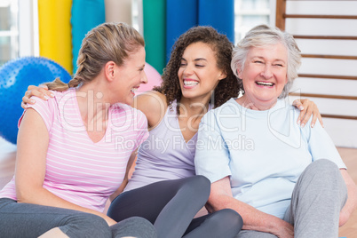 Female friends sitting in gym