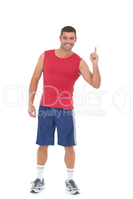 Fit man smiling and pointing