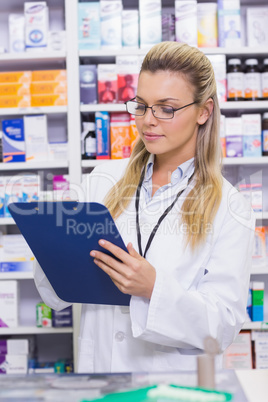 Pharmacist writing on clipboard