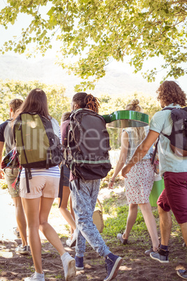 Young friends walking towards their campsite Young friends walking towards their campsite