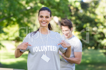 Happy volunteer brunette smiling at the camera