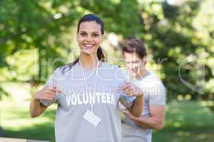 Happy volunteer brunette smiling at the camera