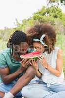 Young couple on a picnic eating watermelon