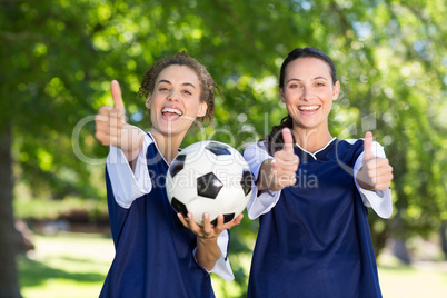 Pretty football players smiling at camera