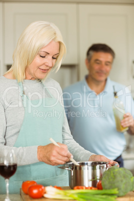 Happy mature couple making dinner together