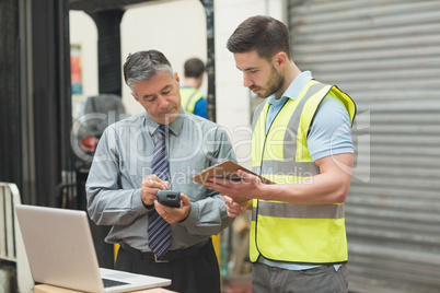 Workers scanning package in warehouse