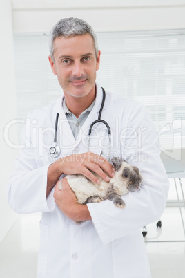 Veterinarian with a rabbit in his arms