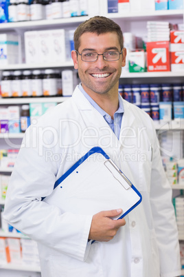 Happy pharmacist holding clipboard