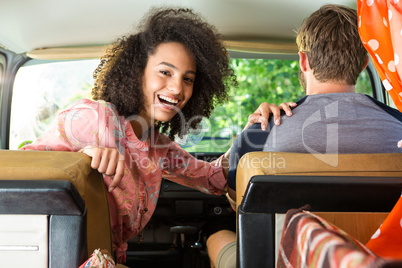 Hipster couple driving in camper van