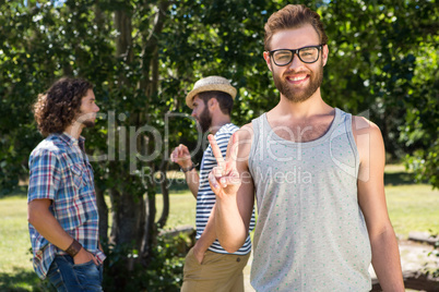 Hipster smiling at camera in the park