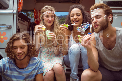 Hipsters blowing bubbles in camper van Hipsters blowing bubbles in camper van