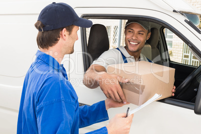 Delivery driver handing parcel to customer in his van