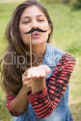 Pretty brunette with fake mustache