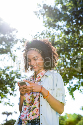 Pretty hipster using her smartphone