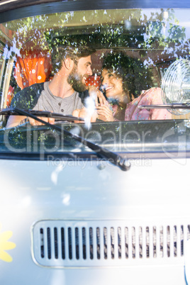 Hipster couple driving in camper van