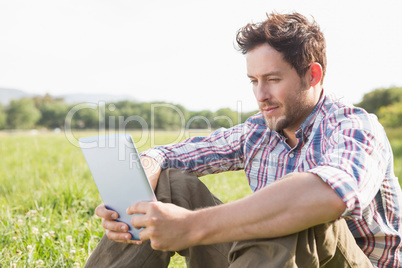 Young man using tablet in the countryside