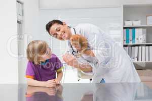 Veterinarian doing injection at a cat with its owner